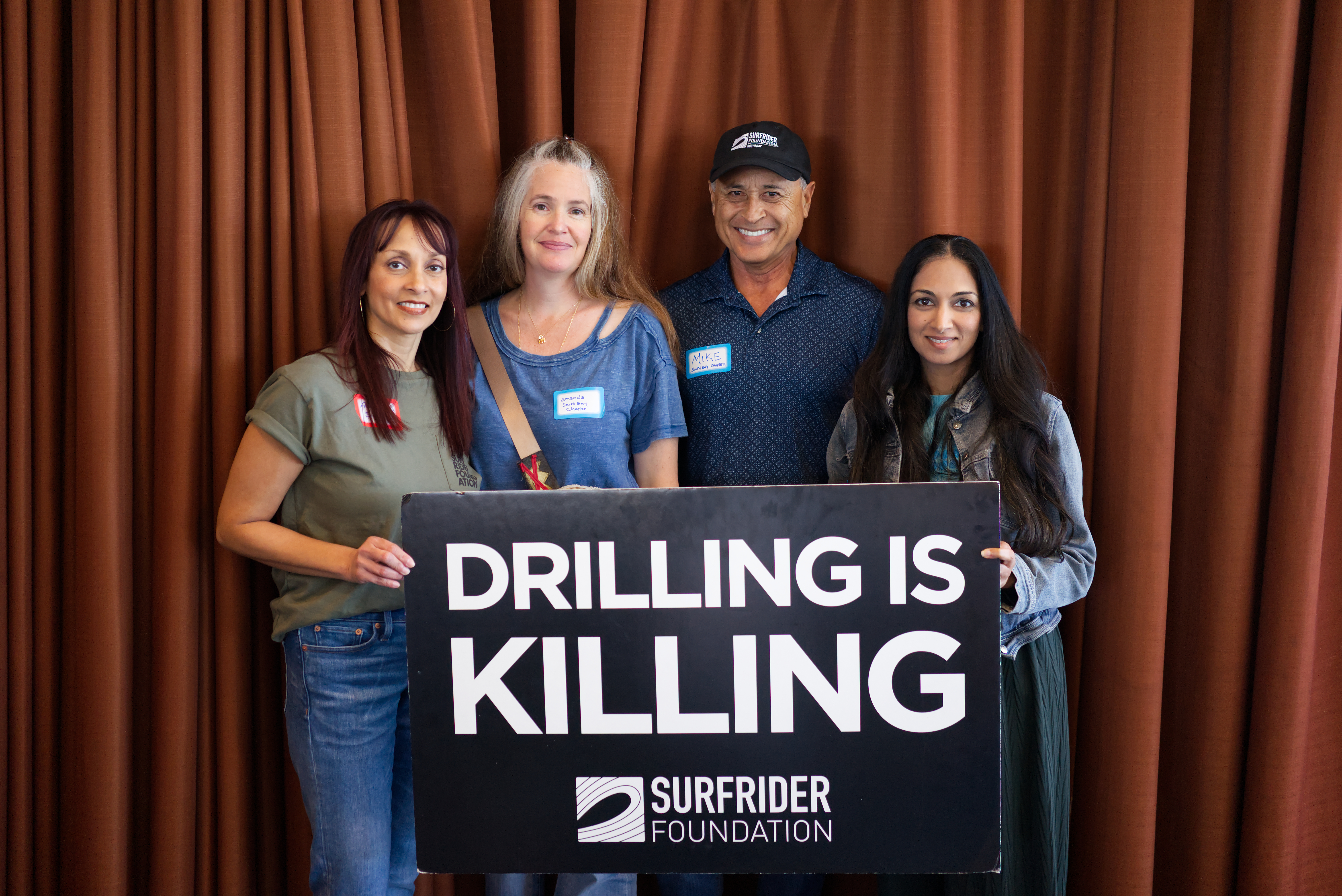 group posing with drilling is killing sign