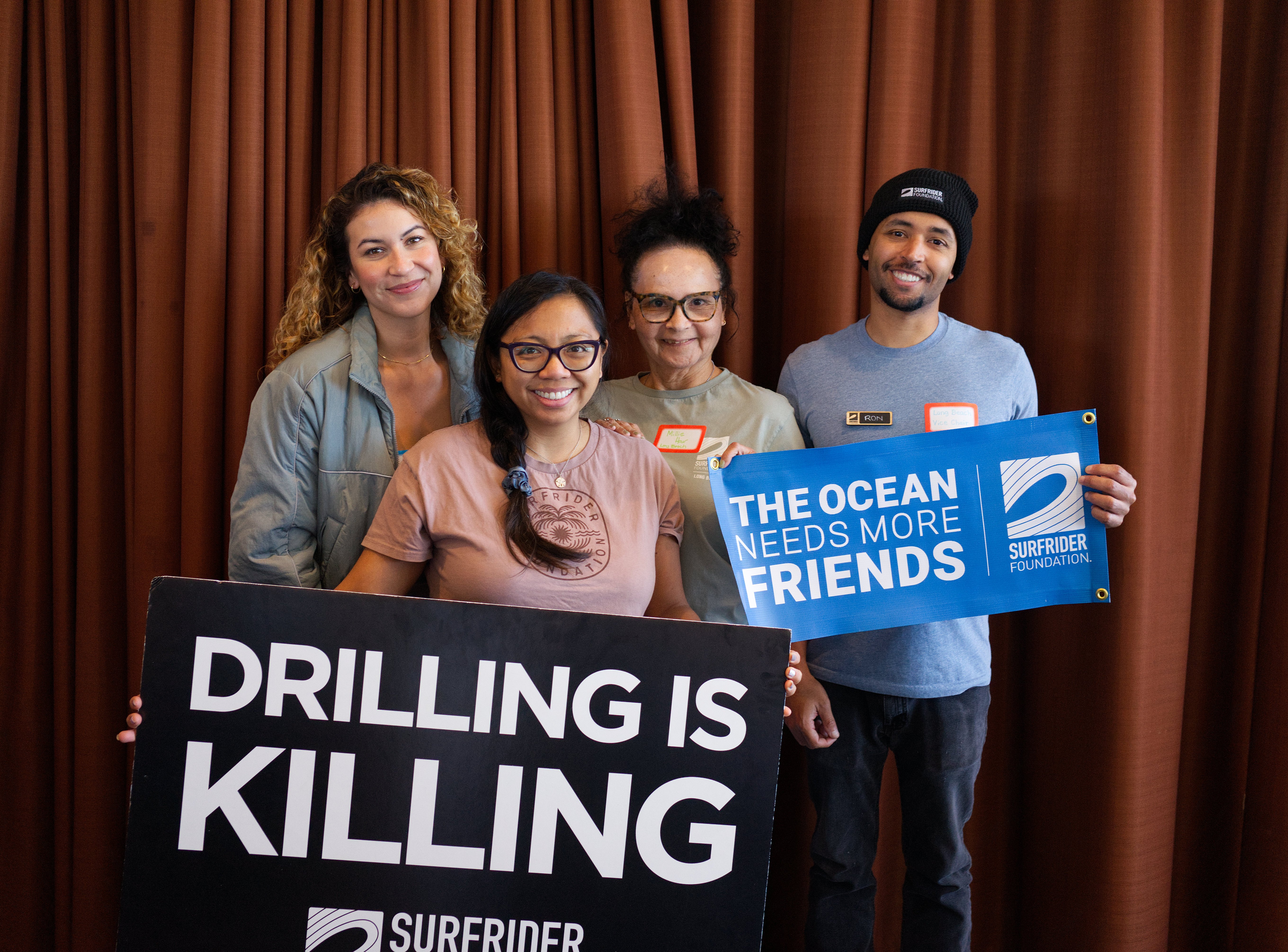 group posing with surfrider signs