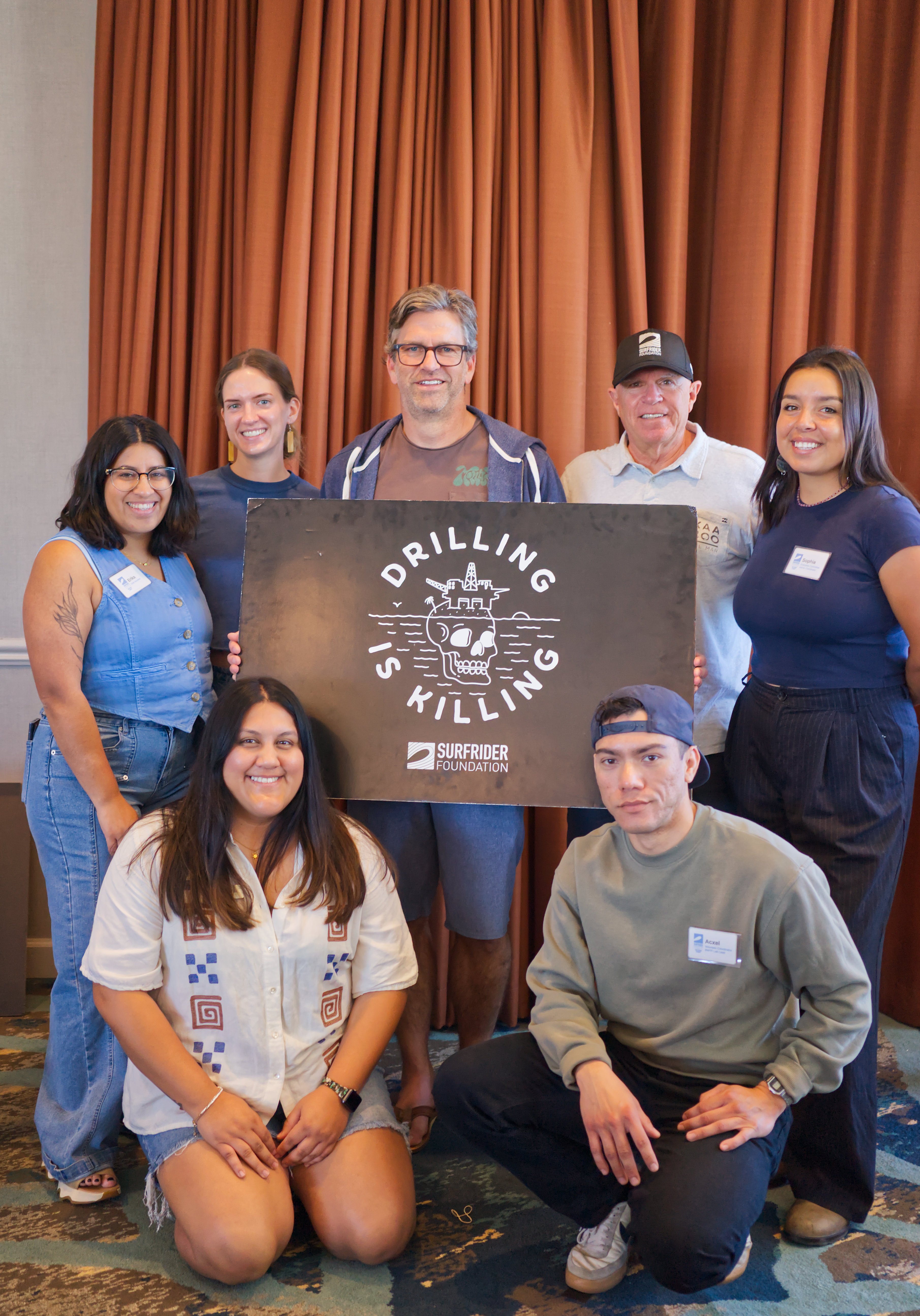 group posing with drilling is killing sign