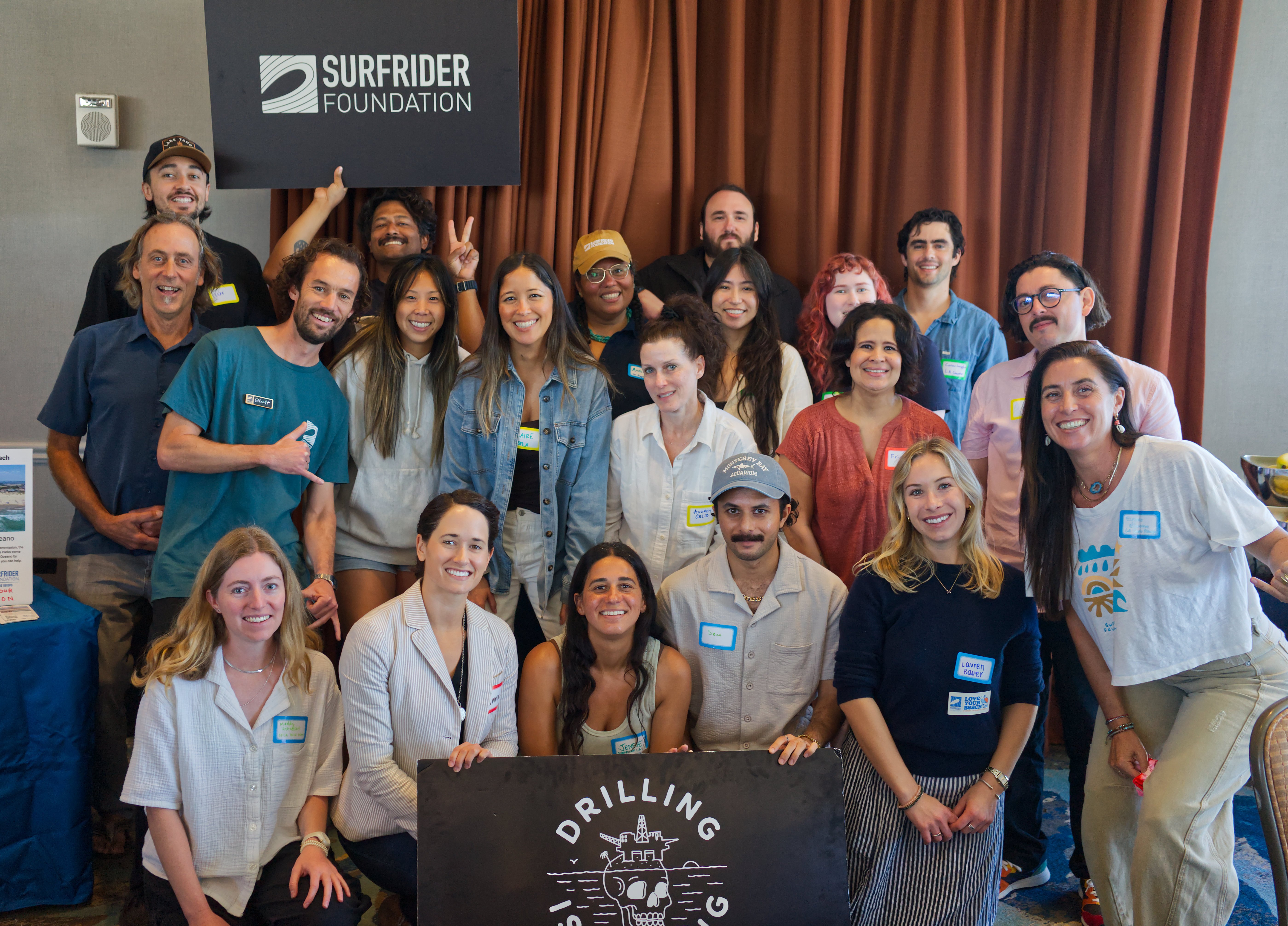 large group posing with surfrider signs