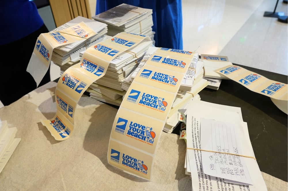 A stack of 'Love Your Beach' postcards signed and ready to deliver.