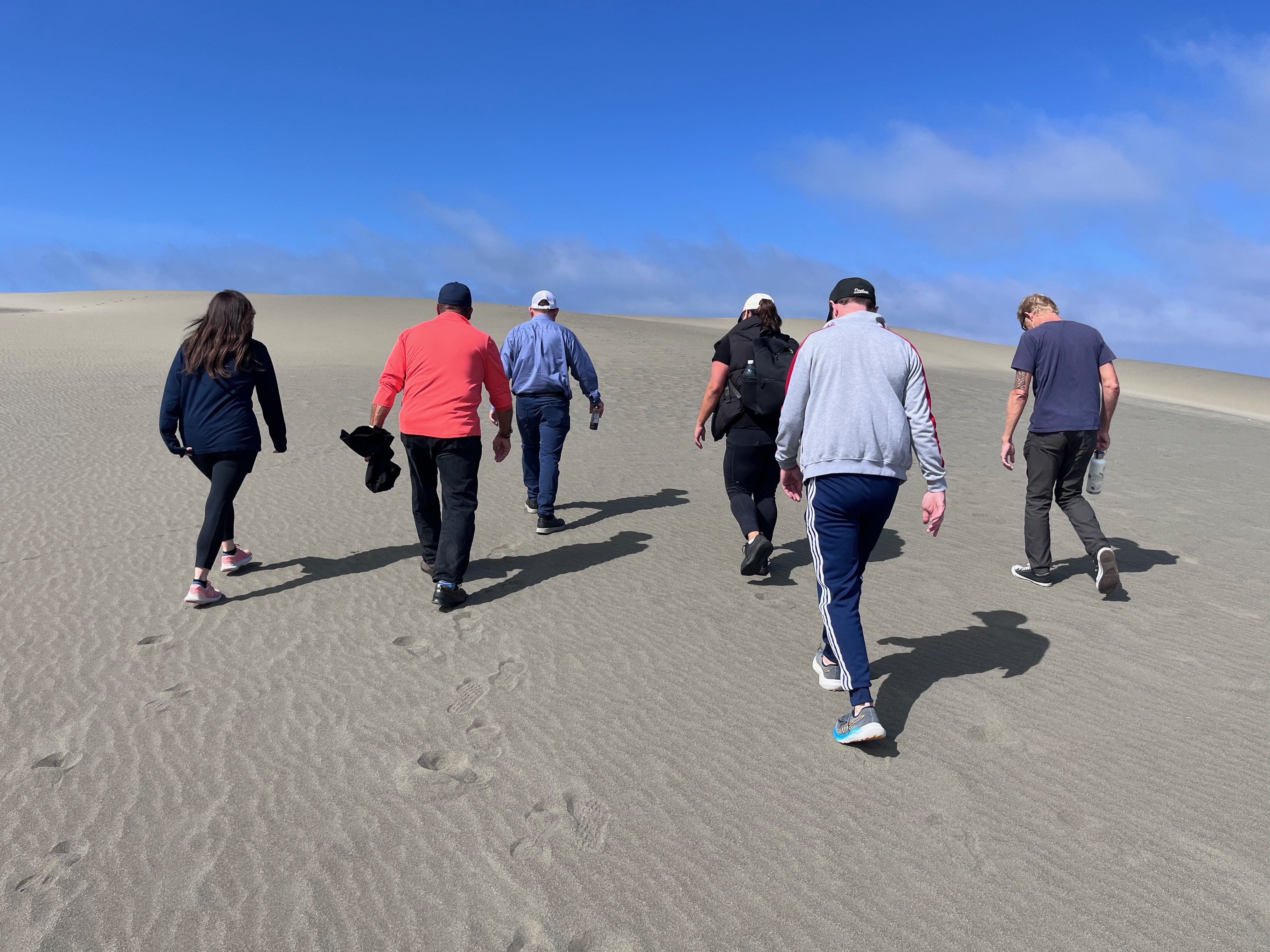 Commissioners hiking the Me-le'l dunes near Arcate
